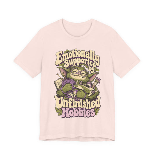 Emotionally Supported by Unfinished Hobbies — Unisex Tee